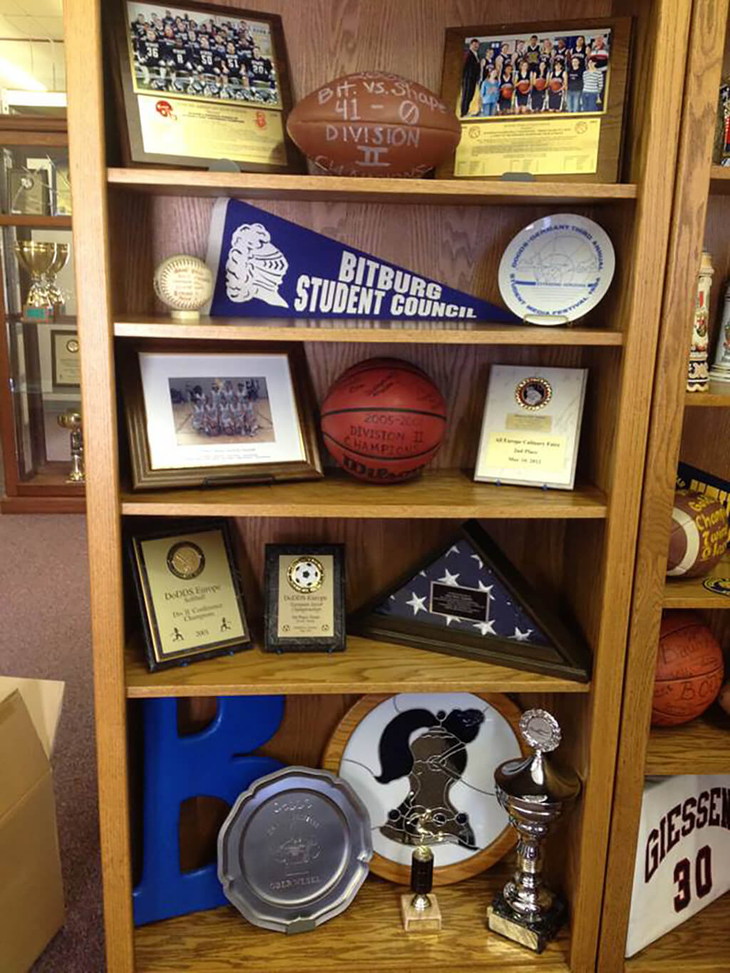 A bookshelf showcasing some of the the memorabilia AOSHS has collected.